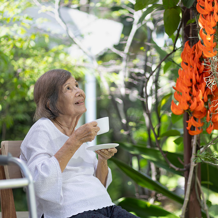 Elderly lady enjoying her backyard