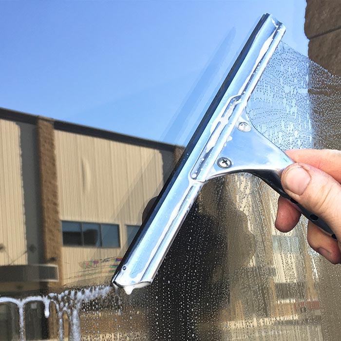 Closeup of squeegee cleaning a window